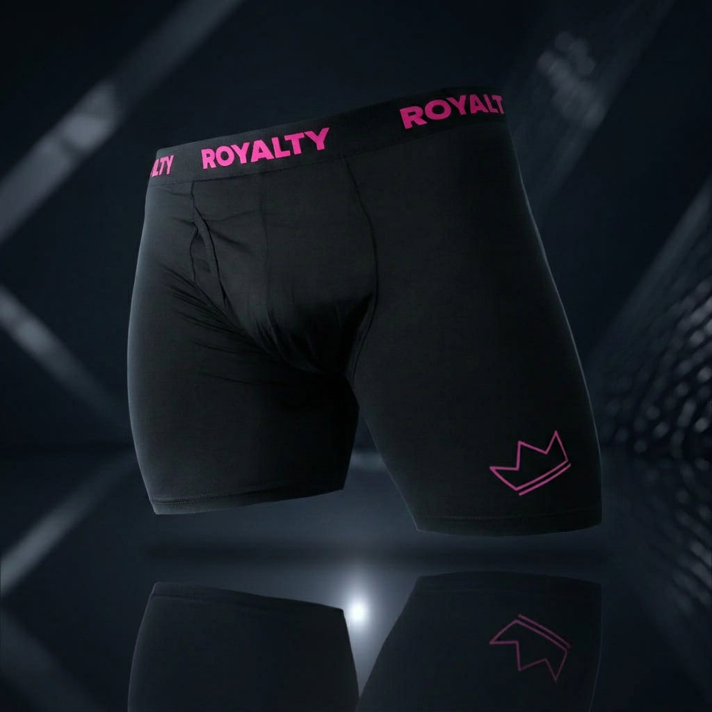 RoyaltyU black boxer briefs with pink ROYALTY waistband and crown logo on a premium dark reflective surface